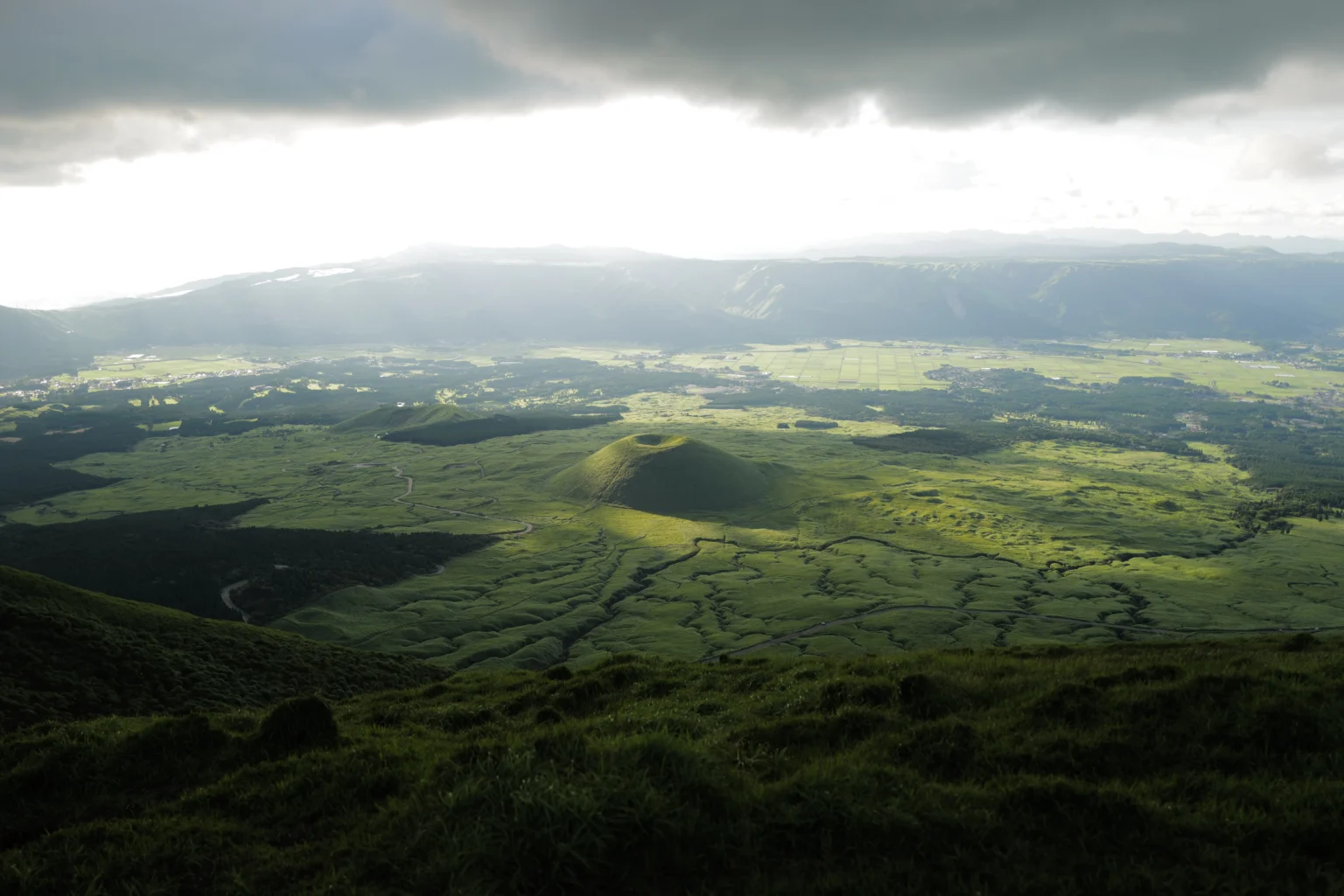 Kusasenri grassland with horses below the Aso volcanic peaks, Kumamoto
