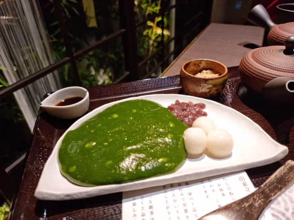 The full dessert plate of matcha warabi mochi, complete with dango and red bean paste, at the Saryo Suisen Kyoto tea house.