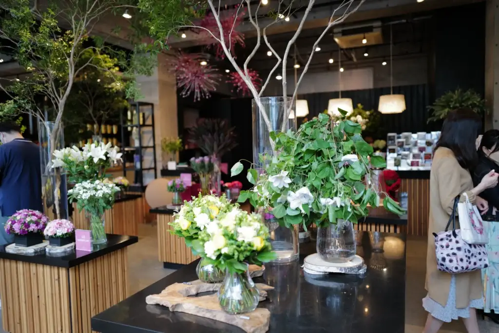 The vibrant interior of the Nicolai Bergmann flower shop in Aoyama, filled with colorful bouquets and floral arrangements.