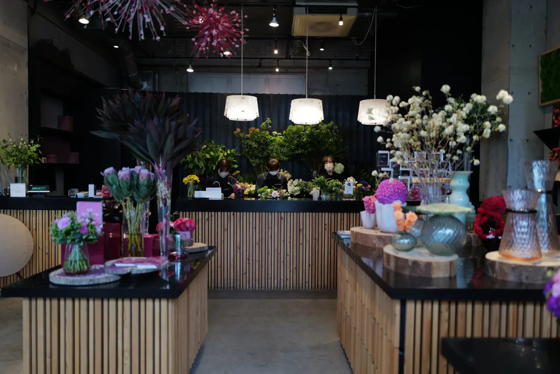 The flower counter at Nicolai Bergmann Aoyama, where florists are at work creating beautiful arrangements.