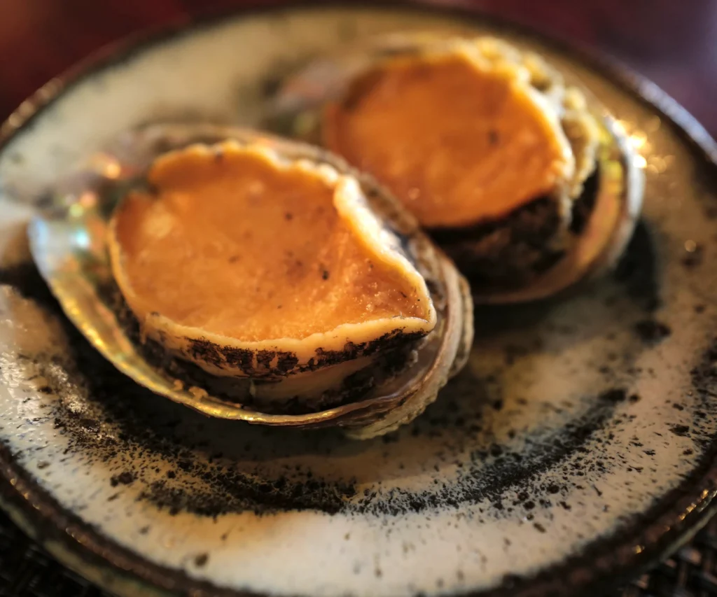 Perfectly steamed abalone served in its shell at Gyosanjin restaurant Saga.