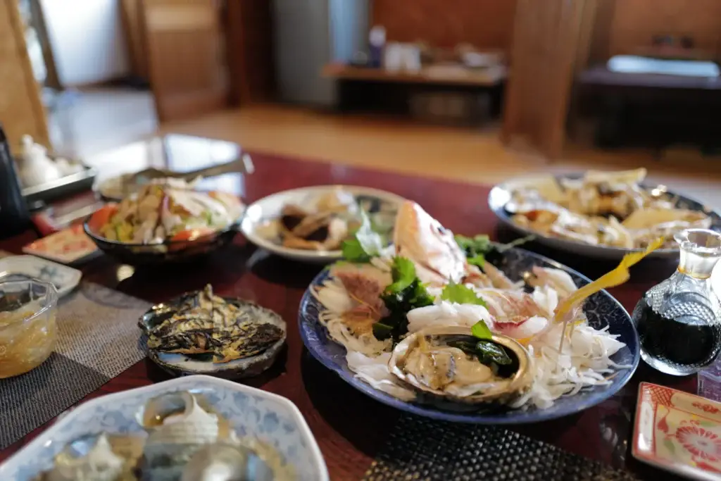 A generous platter of fresh sashimi at Gyosanjin, including sea bream, abalone, and other local fish.