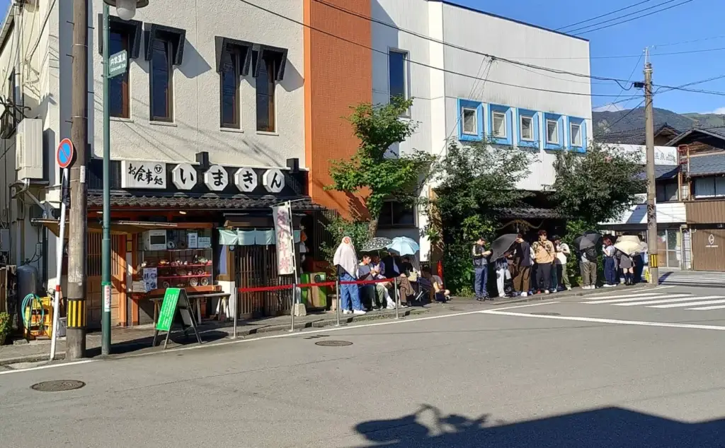 Visitors lining up outside Imakin Shokudo in Aso, a common sight at the popular restaurant.