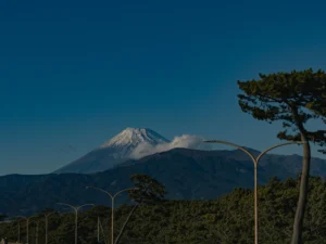 The snow-dusted summit of Mt. Fuji glowing in the morning sun, highlighting the severe beauty of climbing Mt Fuji in winter.