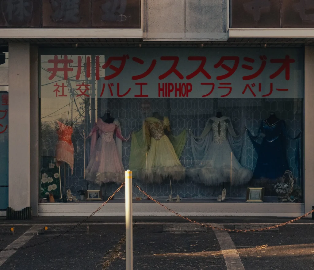 The window display of the old Igawa Dance Studio in Nishiura Fujiyoshida, showing dresses from the Showa era.
