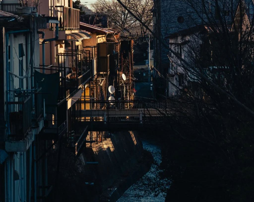 A glimpse of the back alleys and a small canal in the Nishiura district at sunset.