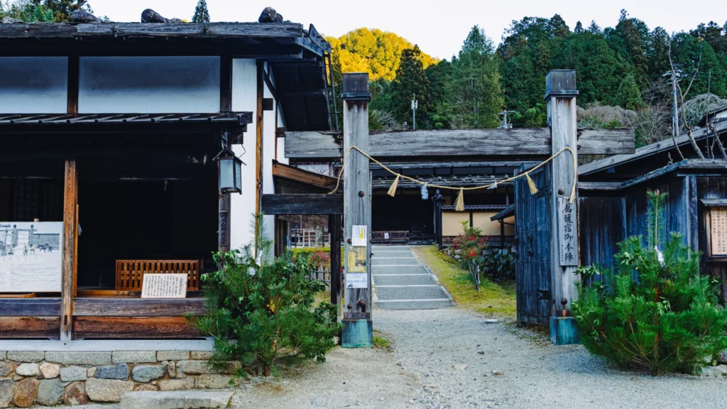The atmospheric Terashita district of Tsumago-juku, featuring traditional stone lanterns and water basins that have served travelers for centuries.