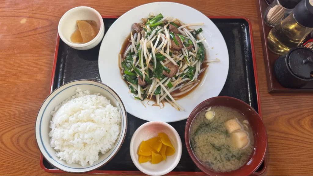 The menu at Gensuke restaurant showing a variety of dishes including ramen from 680 yen, set meals (teishoku) from 930 yen, rice bowls, and side dishes, all written in Japanese with prices.
