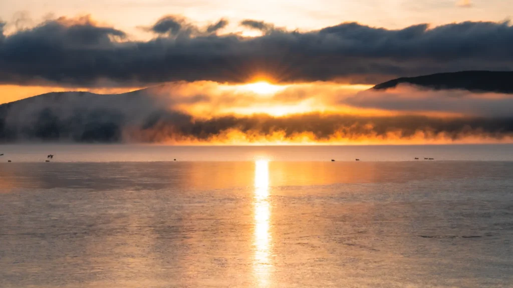 A dramatic sunrise over Lake Yamanakako, highlighting access to this scenic spot.