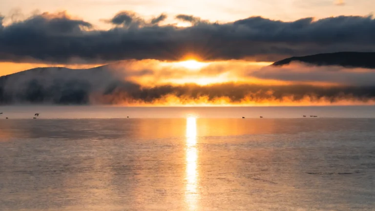 A dramatic sunrise over Lake Yamanakako, highlighting access to this scenic spot.