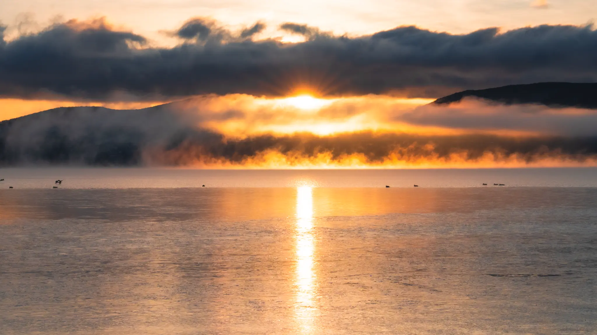 A dramatic sunrise over Lake Yamanakako, highlighting access to this scenic spot.