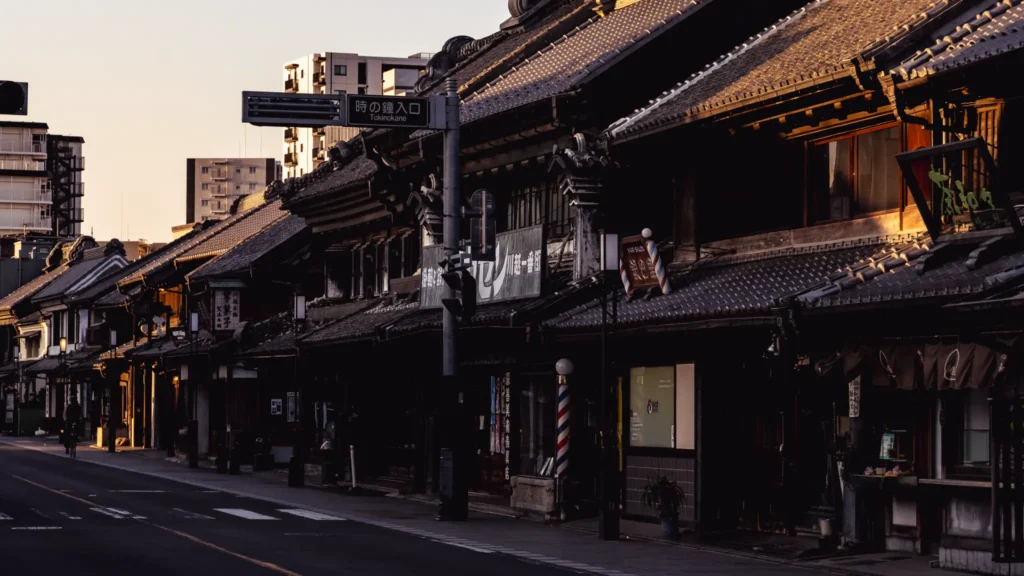 The entrance sign to the Toki no Kane bell tower area in Kawagoe, with Kurazukuri buildings visible in the background.