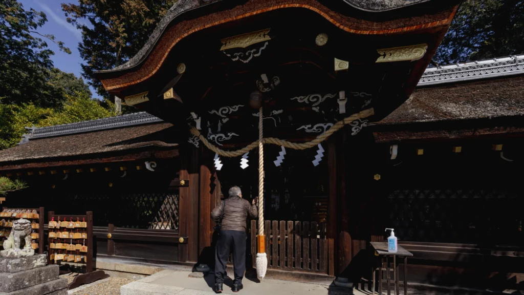 A visitor purifies their hands at the chozuya (water pavilion) before praying.