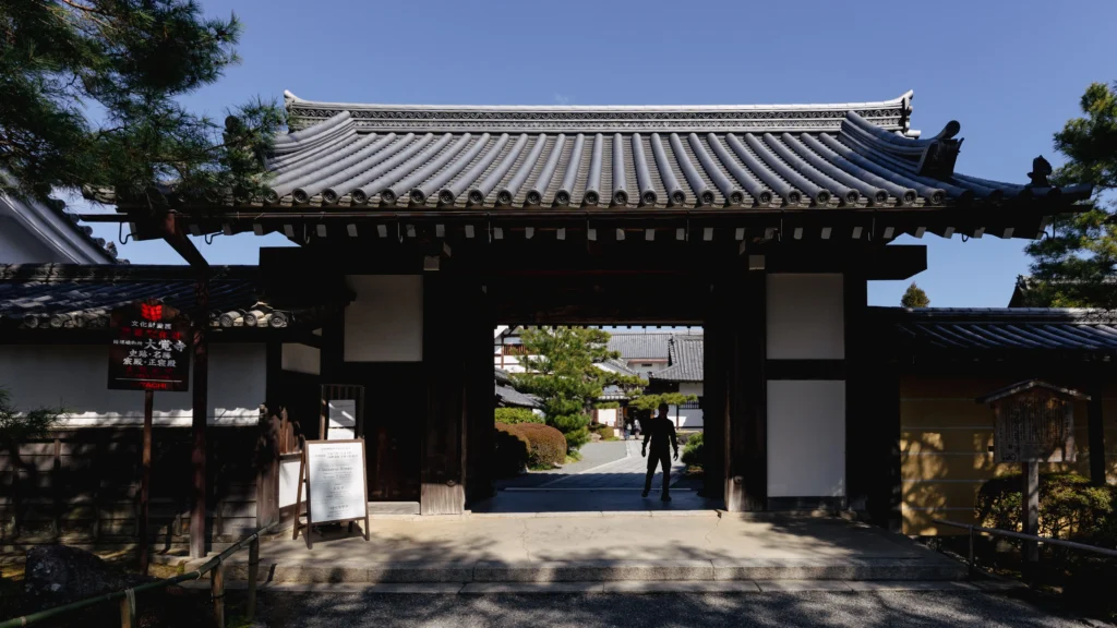 The main entrance gate to Daikakuji Temple, with its traditional wooden structure and stone steps.