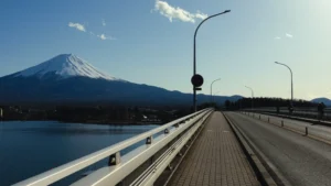 Panoramic view of snow-capped Mt. Fuji seen from the pedestrian walkway of Kawaguchiko Ohashi Bridge