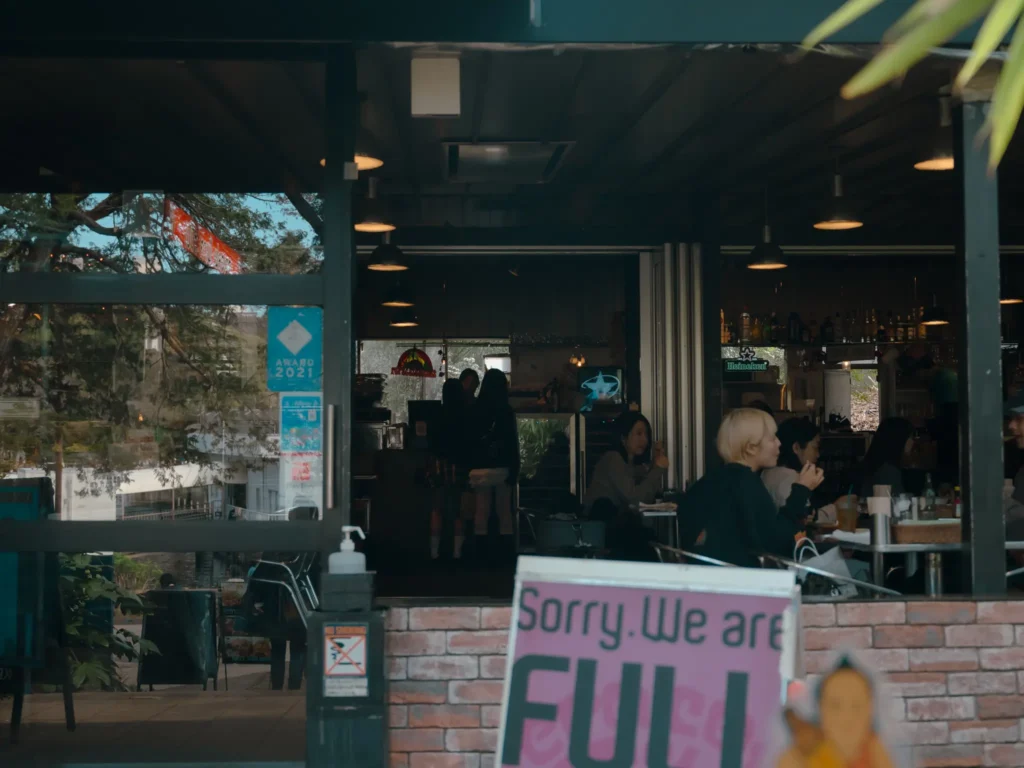 The exterior of Pepacafe Forest, with a sign that reads "Sorry. We are FULL."