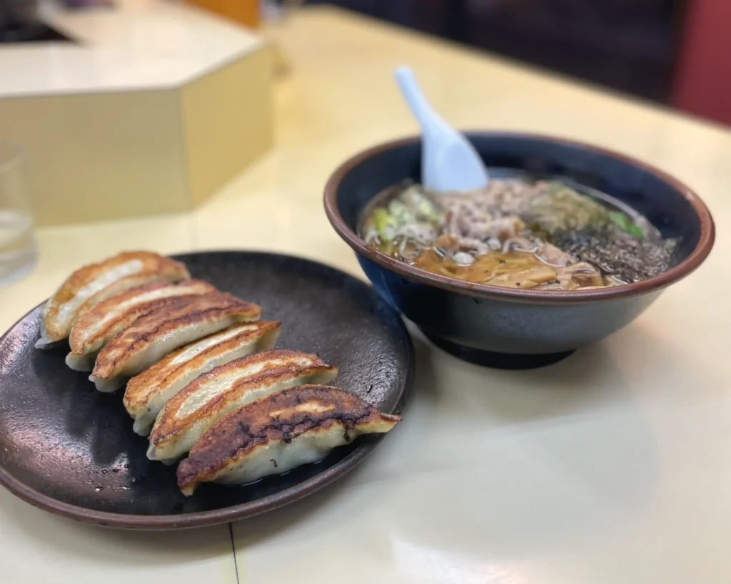 The classic combination: a bowl of Tokusei Juhachiban ramen paired with a plate of crispy gyoza.
