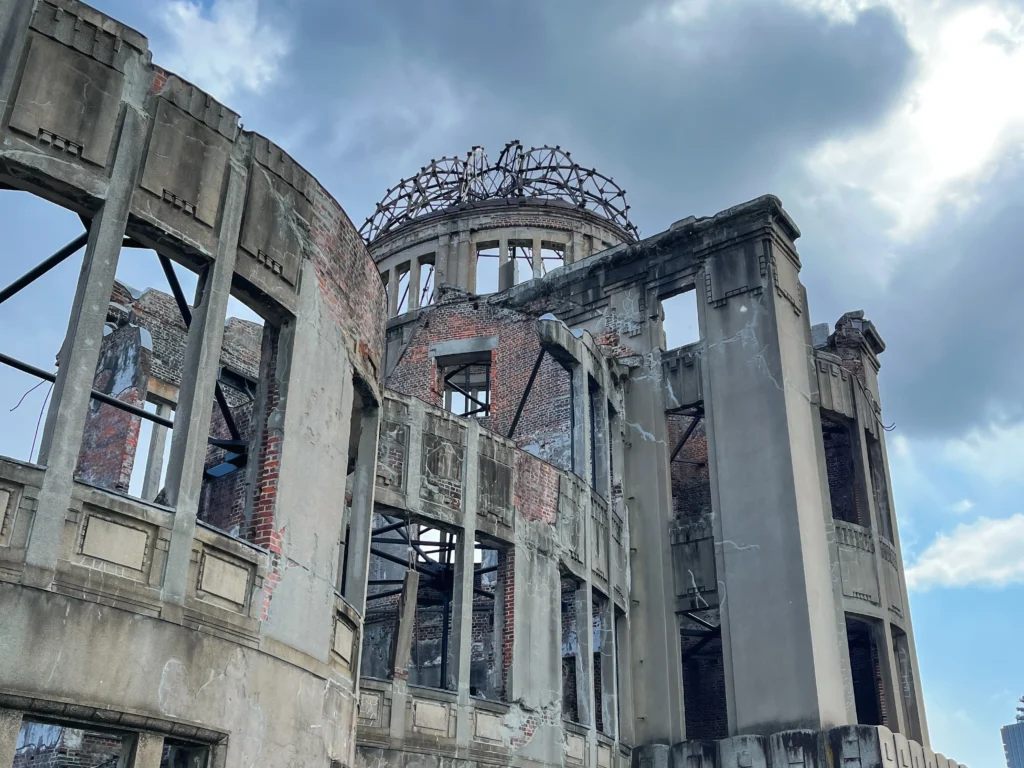 The Atomic Bomb Dome in Hiroshima, looking up at the skeletal steel frame against the sky