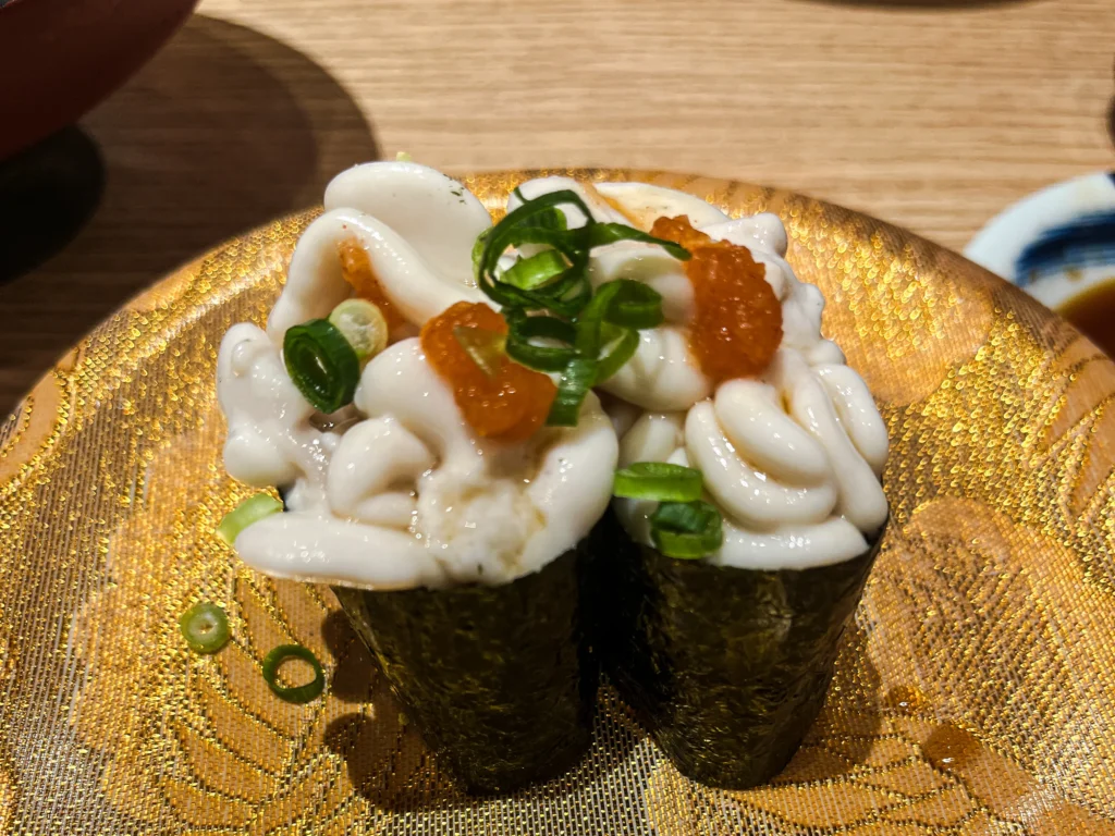Shirako (cod milt) gunkan-maki topped with momiji-oroshi at Sushi Tatsu in Hiroshima