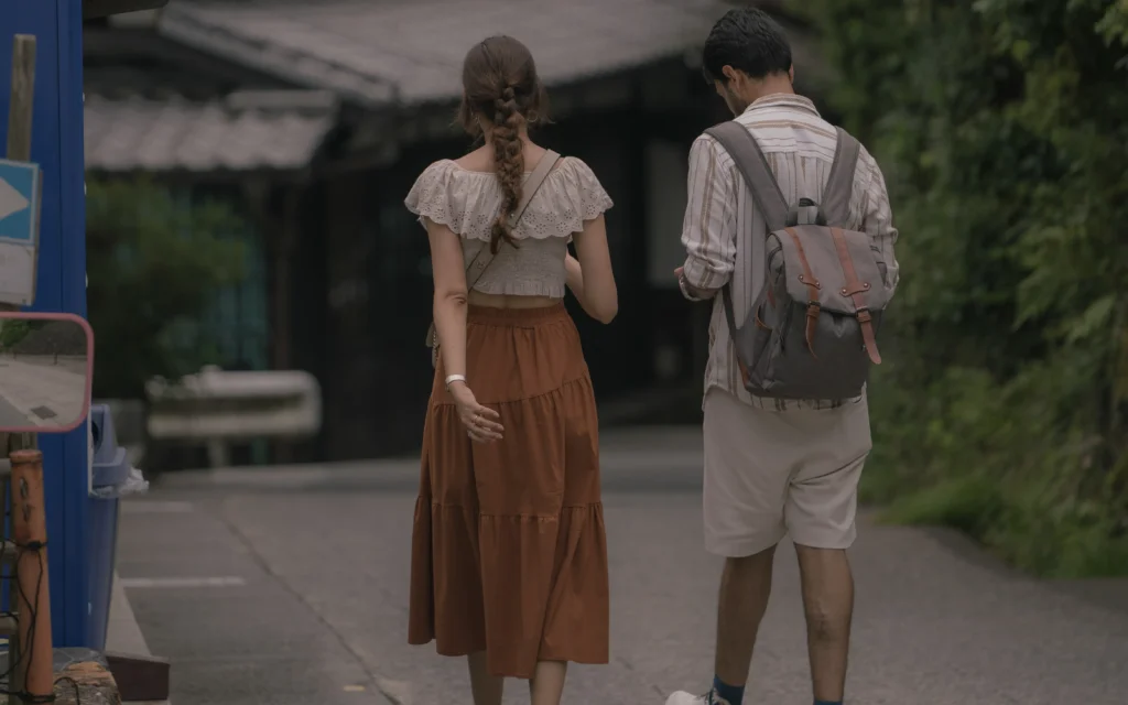Close-up of a couple walking in summer clothes along the preserved street