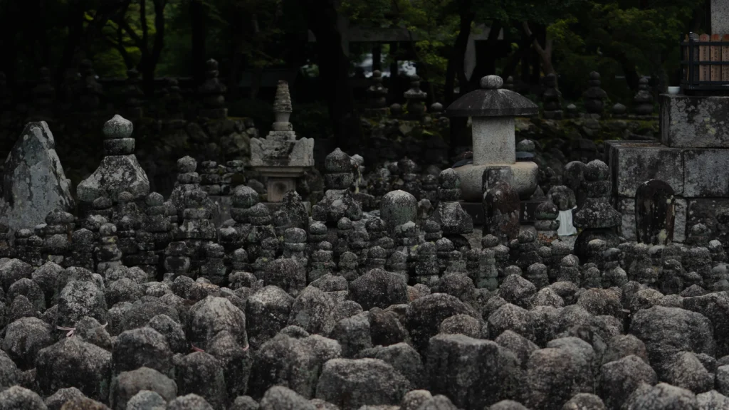 Hundreds of weathered stone Buddha statues with stone lantern at Adashino Nenbutsuji Kyoto