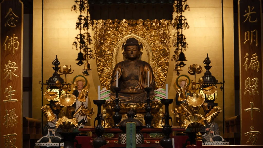 Ornate golden altar with seated Amida Buddha statue at Adashino Nenbutsuji main hall