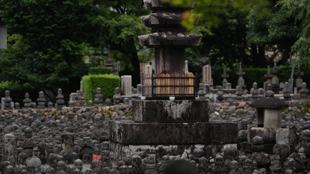 Multi-tiered stone gorinto stupa surrounded by stone Buddhas at Adashino Nenbutsuji