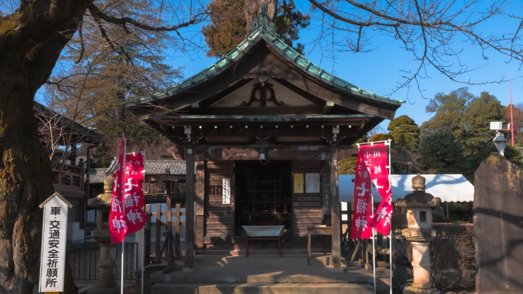 Traffic safety prayer hall at Kitain Temple with red banners and traditional architecture