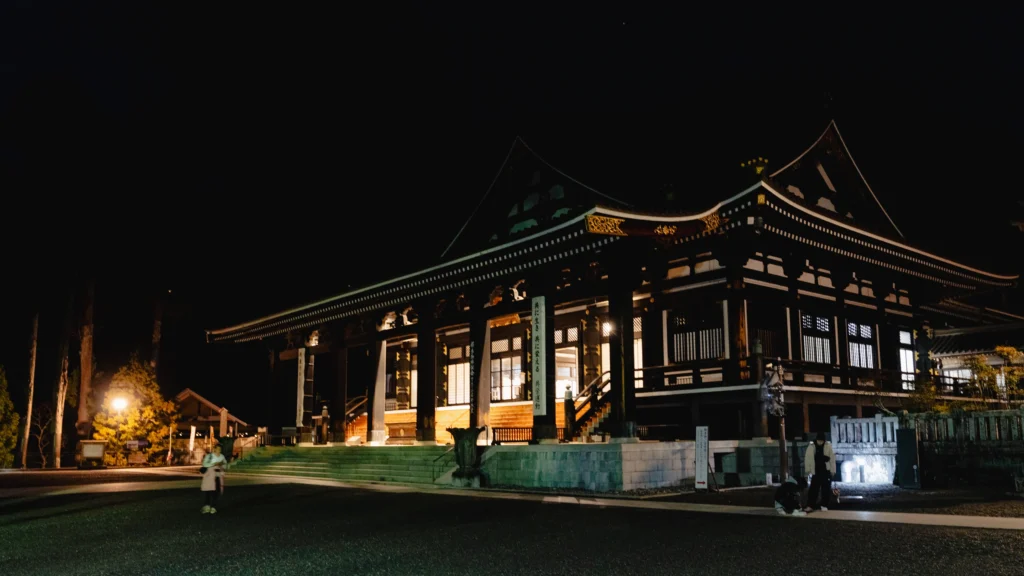 Kuonji Temple main hall illuminated at night — where the 5:30 AM morning prayer service takes place