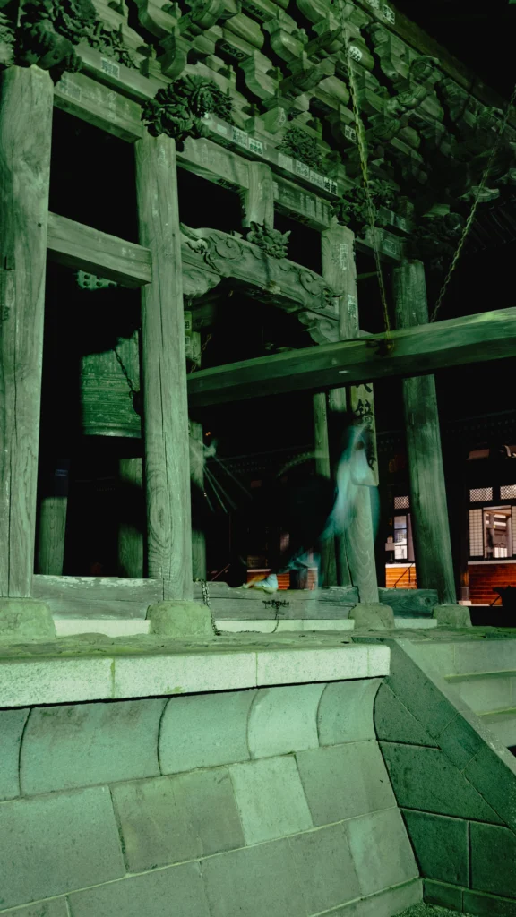 A monk at Kuonji Temple leaning his entire body backward to swing a massive wooden beam into the Great Bell
