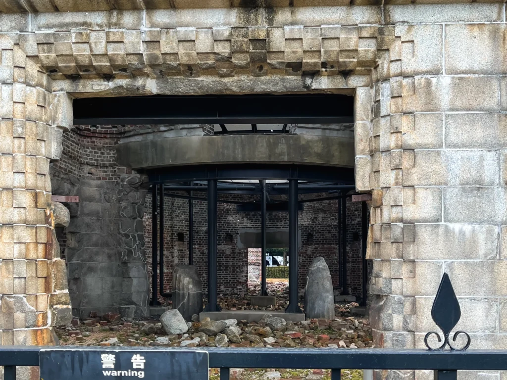 A fenced-off section near the Atomic Bomb Dome with cherry blossom petals on the ground