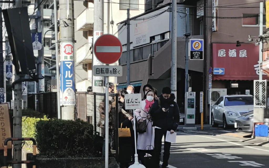 Line of customers waiting outside Onigiri Bongo on Otsuka residential street