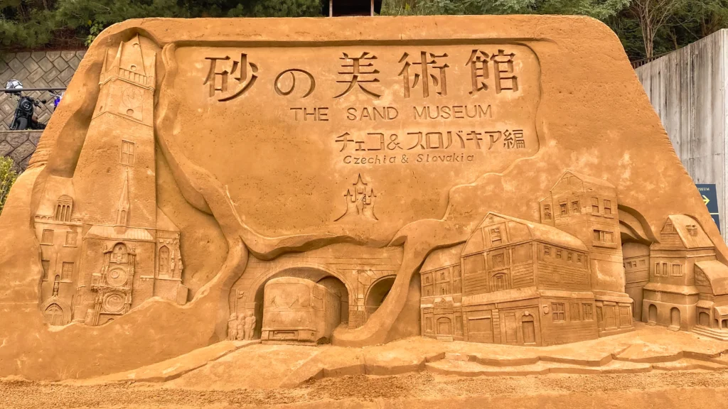 Welcome sand sculpture at the museum entrance depicting a European townscape
