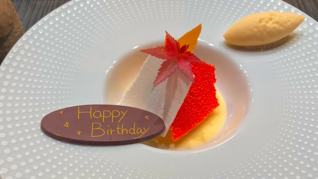 A special birthday dessert featuring a momiji (autumn maple) theme with delicate sugar work.