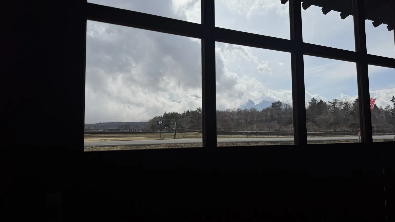 View through Hanaan window toward cloud-covered Mt Fuji