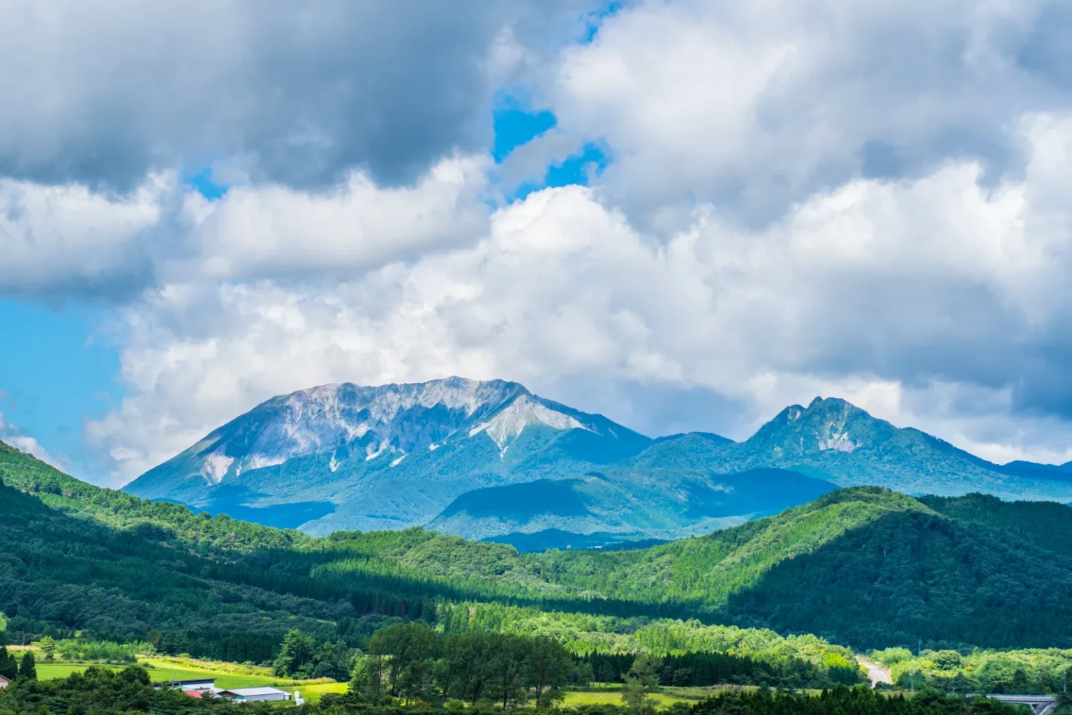 Mt. Daisen rising beyond green highland, seen from Hiruzen