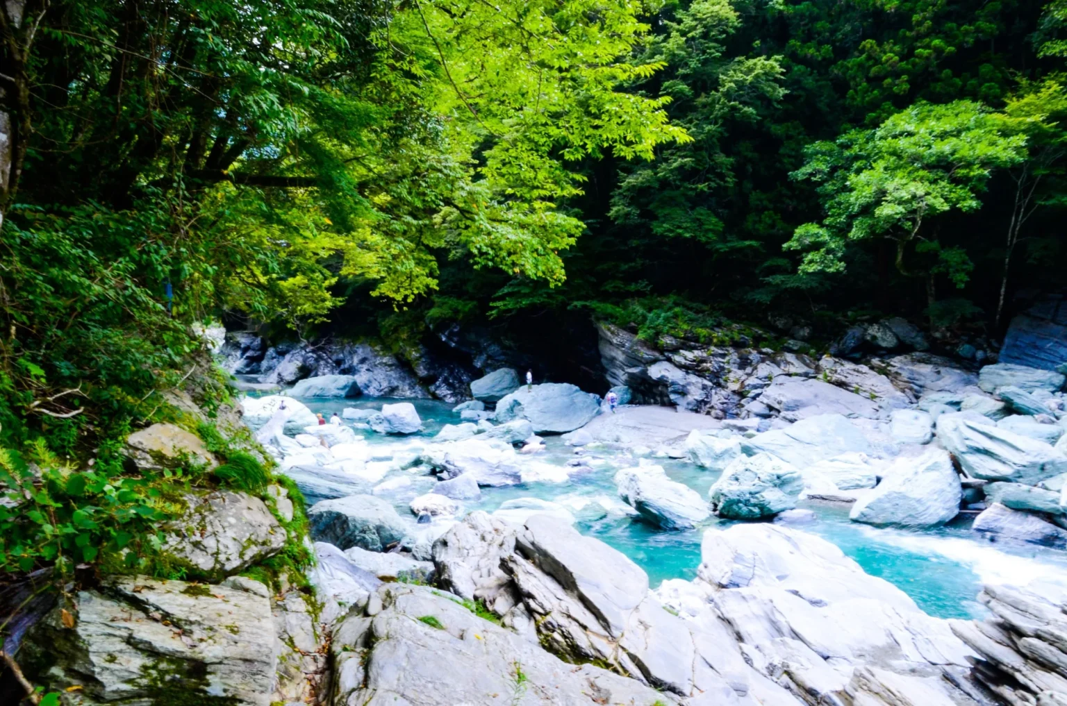Turquoise river and white boulders in the gorge below the Kazurabashi in Iya Valley