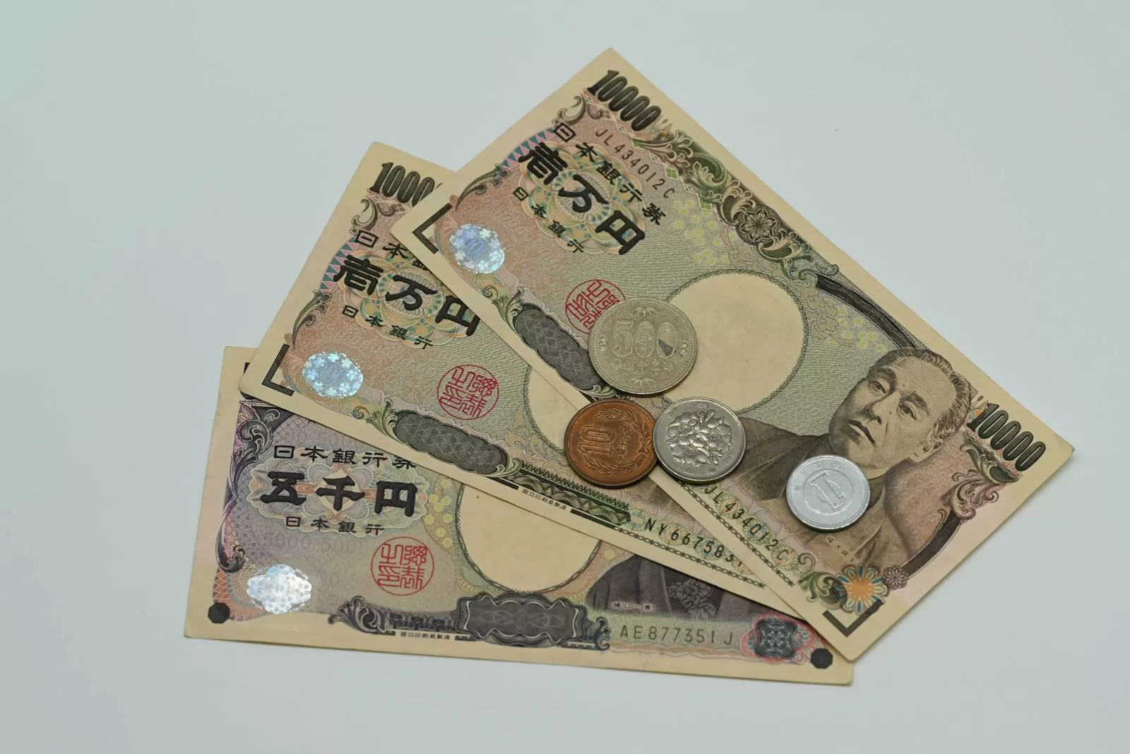 Japanese yen banknotes and coins spread on a flat surface