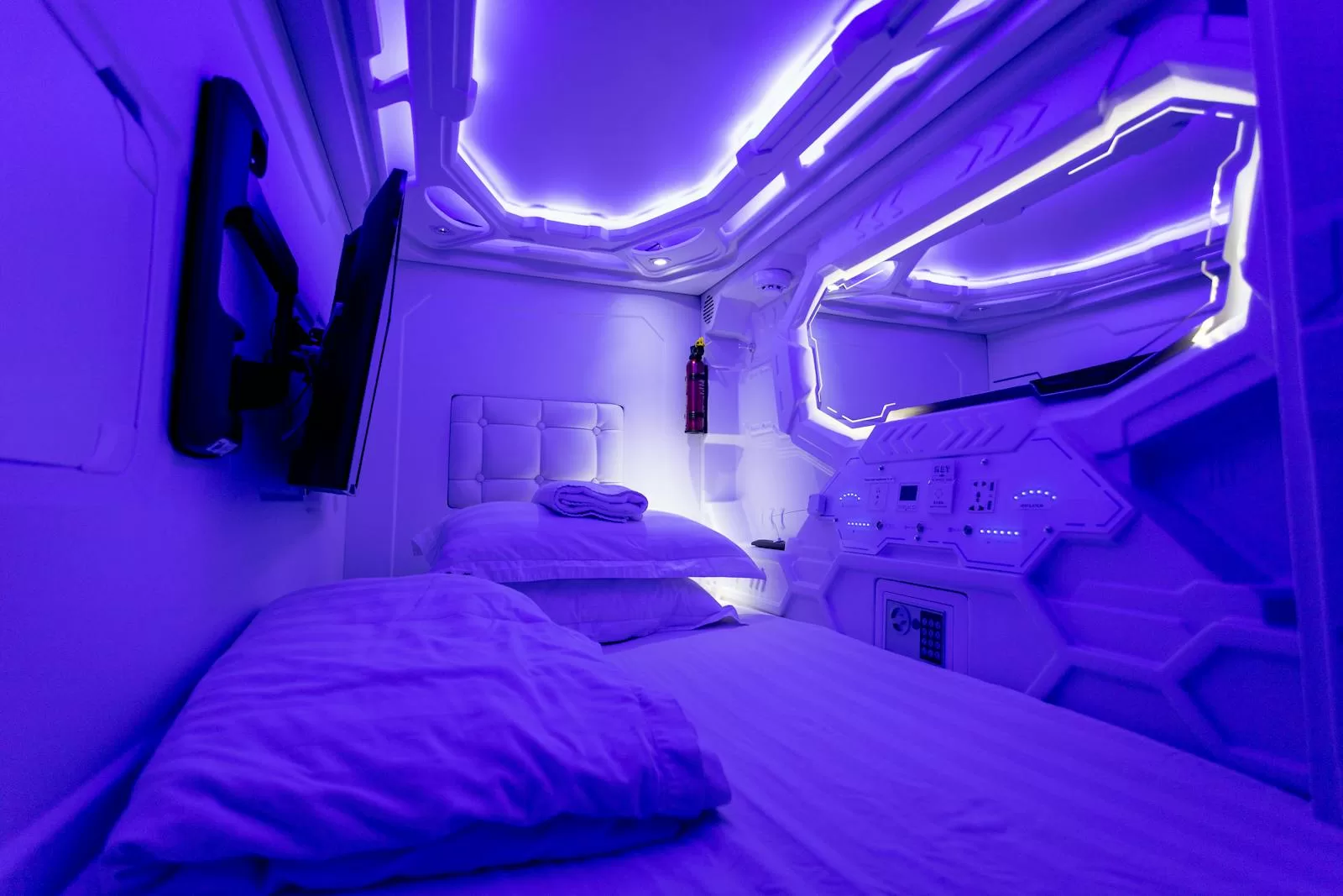 Illuminated capsule hotel interior with stacked sleeping pods