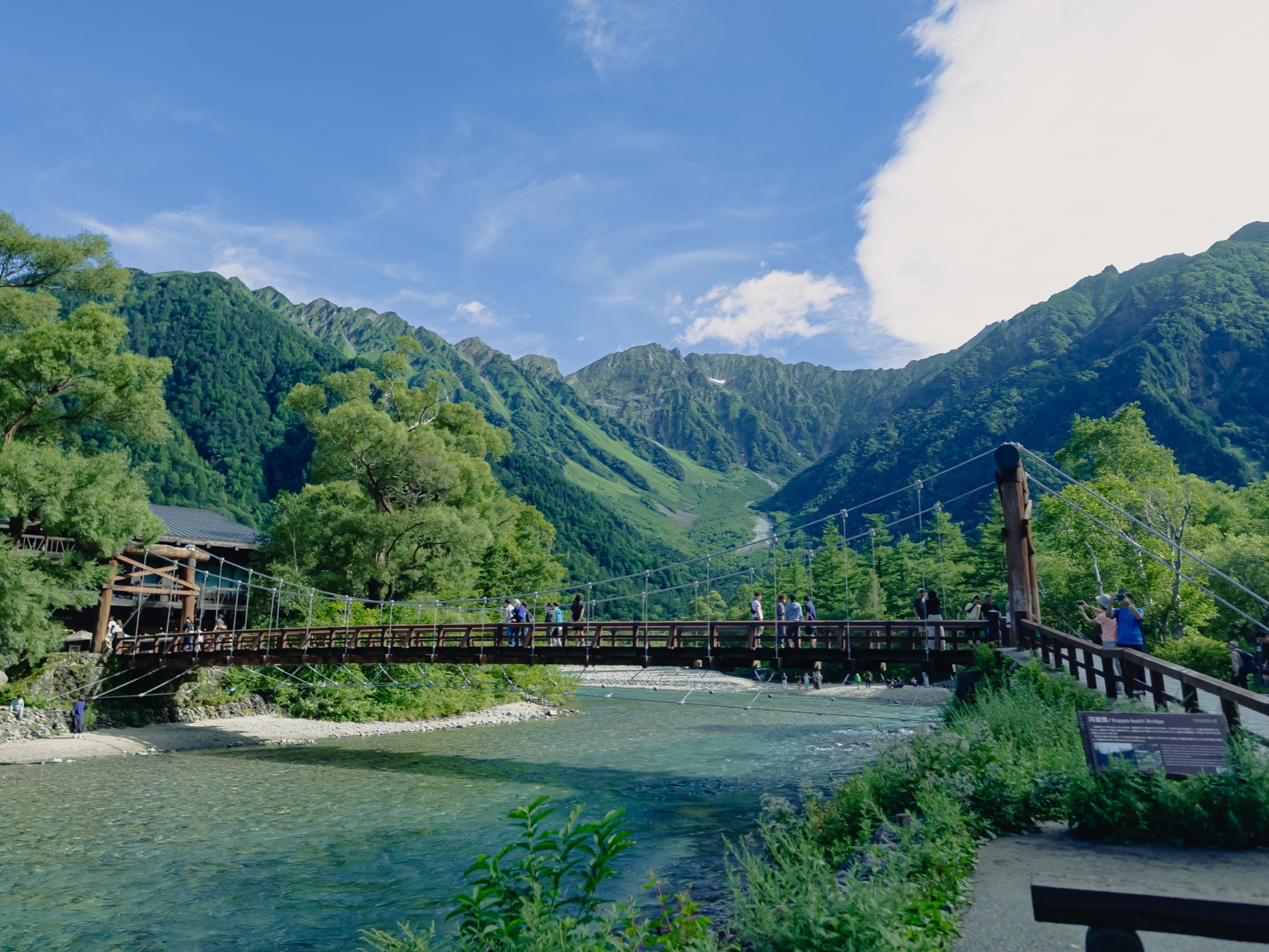 Kappa Bridge spanning the Azusa River with Hotaka mountain peaks in the background at Kamikochi