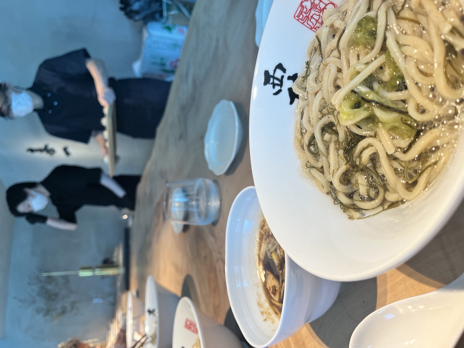 Bowl of kombu ramen with chef working in the background at Kiichi