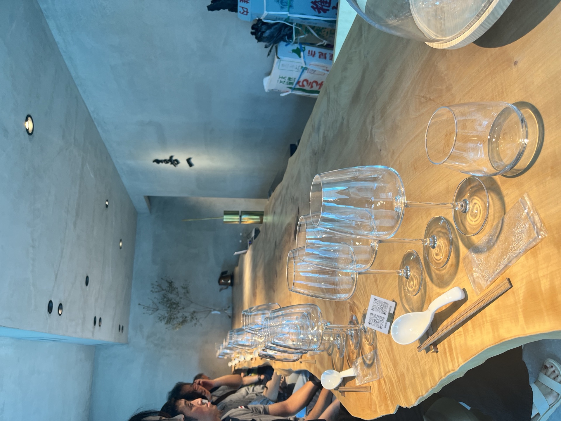 Counter setup with water glasses and ceramic spoons before service at Kiichi