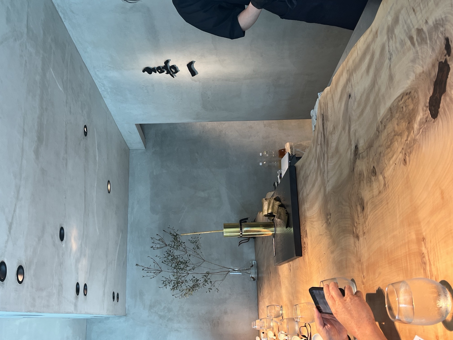 Concrete-wall interior of Kiichi above the Itutuji no Kombu shop with hand-painted open sign