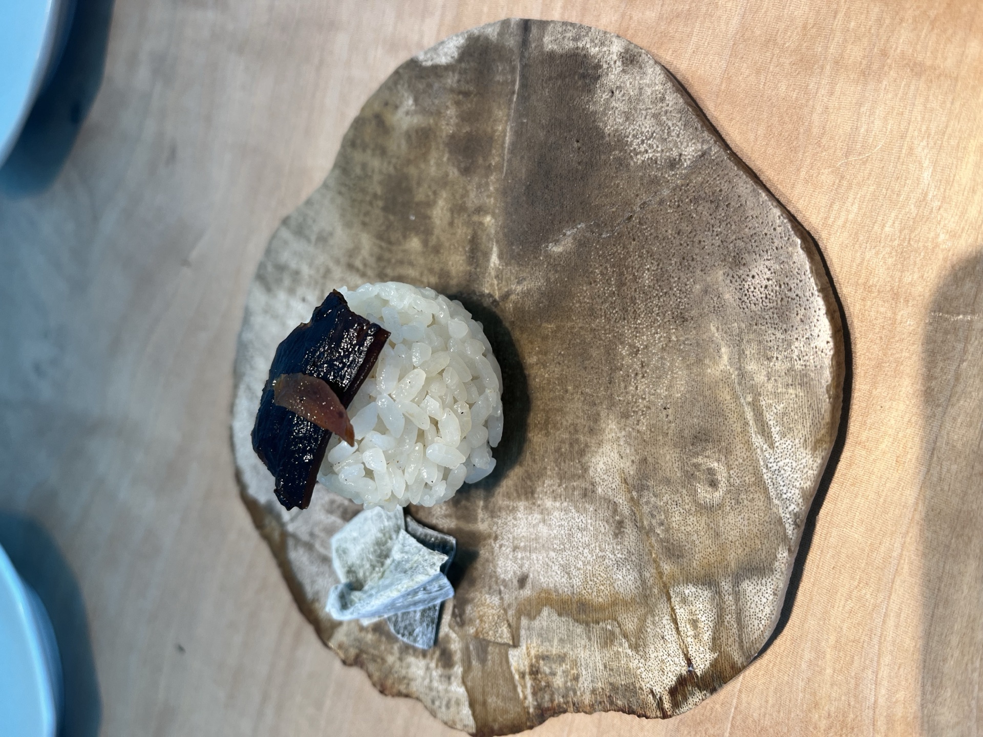 Welcome plate with rice ball and kombu pieces at Kiichi