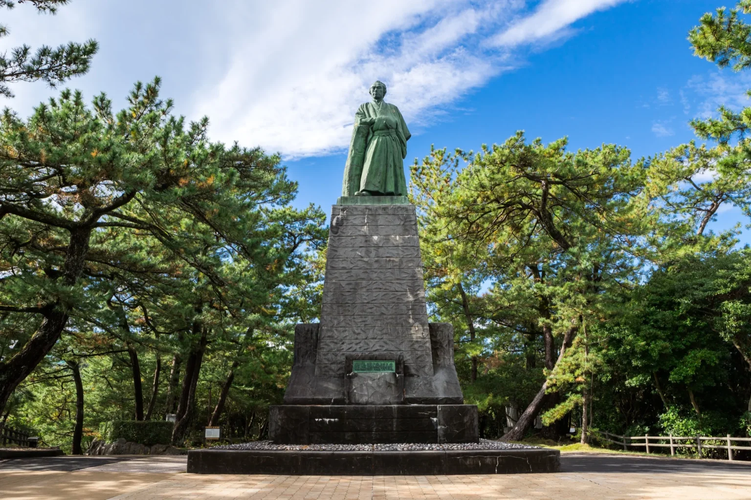 Bronze statue of Sakamoto Ryoma on a tall pedestal facing the Pacific at Katsurahama