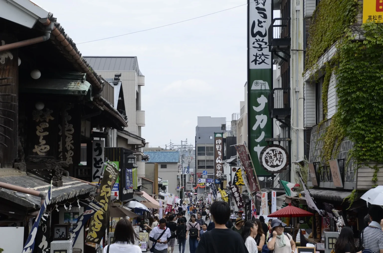 Kotohira shrine approach lined with udon shops, souvenir stalls and noren curtains
