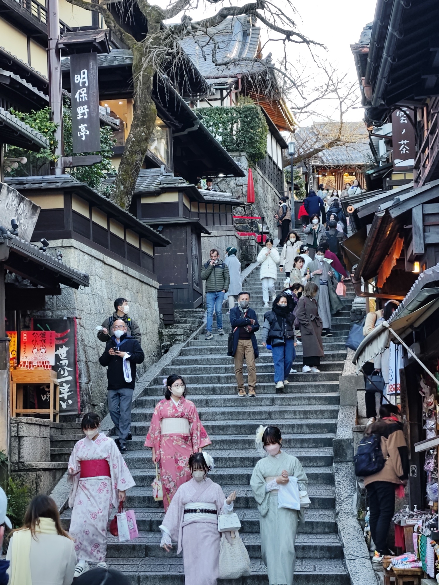 Tourists in rented kimono walking up Sannenzaka, the historic stone-stepped street leading to Kiyomizudera in Kyoto
