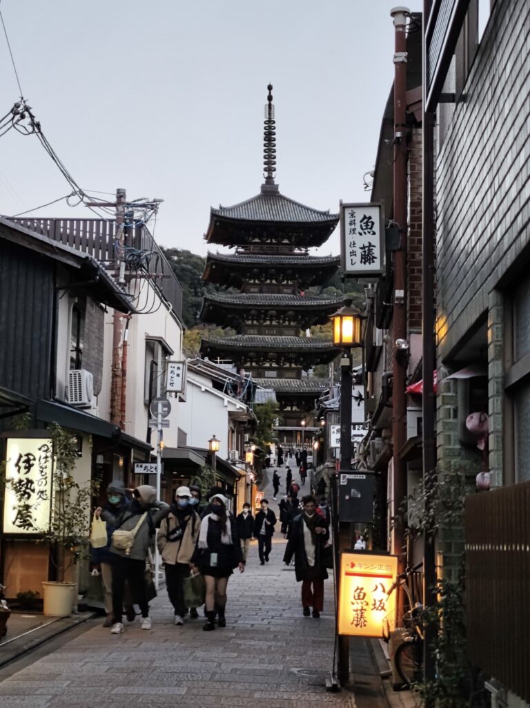 Yasaka-dori cobblestone street at dusk with Yasaka Pagoda framed at end of narrow lane Kyoto
