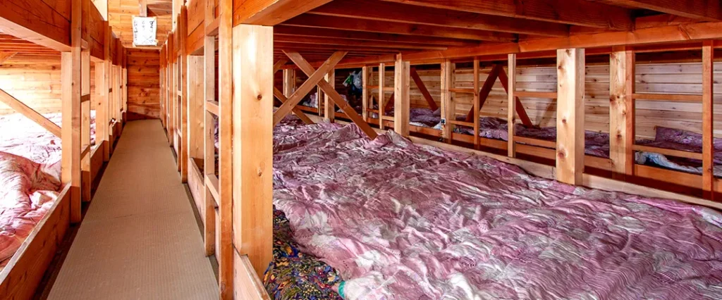 Communal dormitory sleeping platform with futons inside Mt. Fuji mountain hut