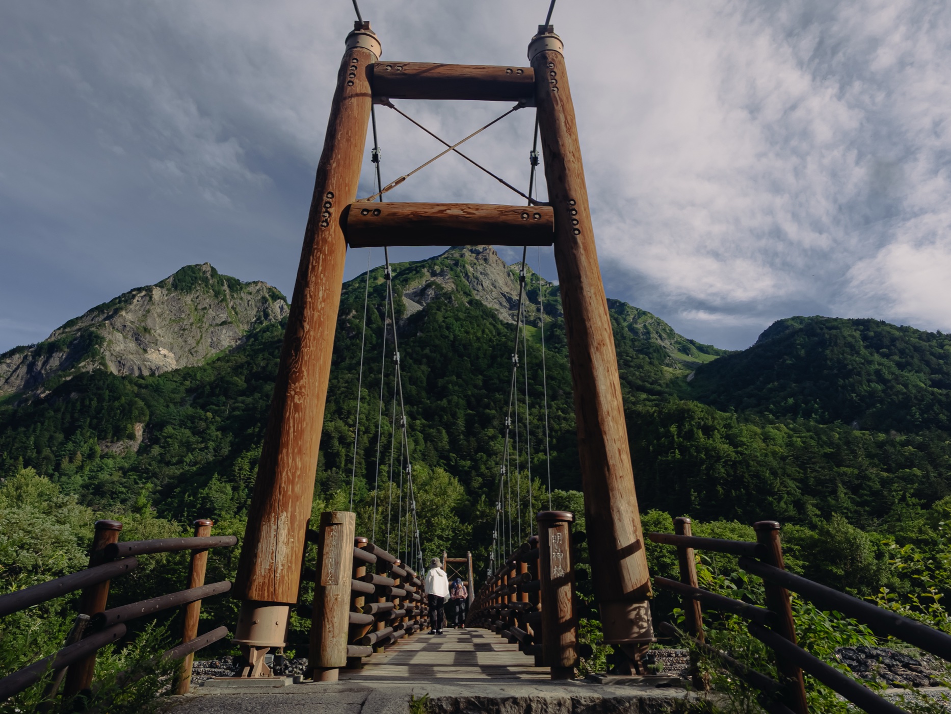 Myojin Bridge wooden suspension bridge framing Myojin-dake mountain peak at Kamikochi
